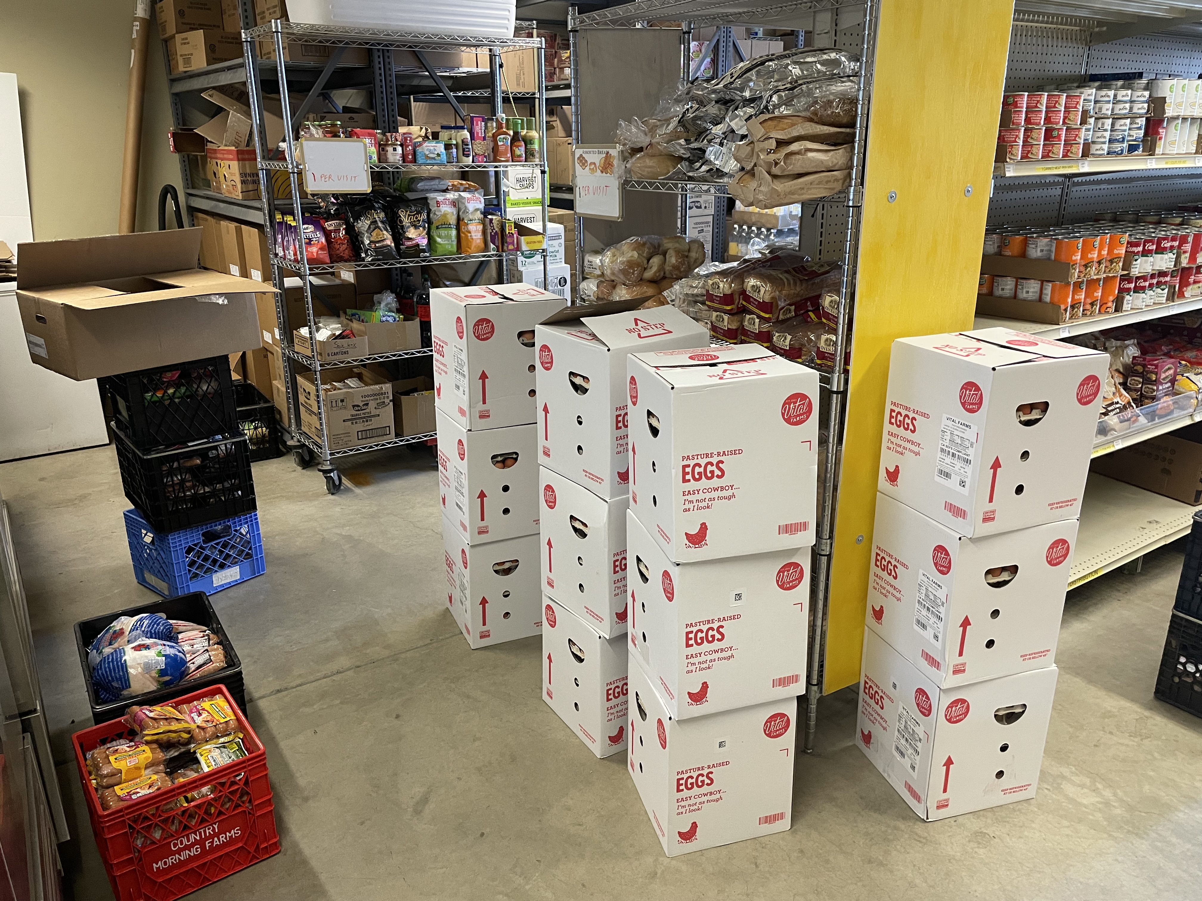 Volunteers restocking pantry shelves